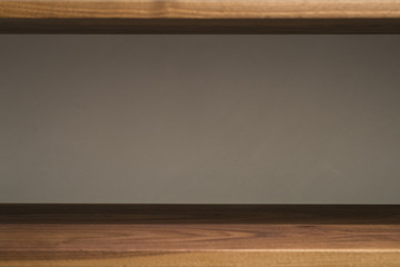 background with walnut shelf against decorative plaster wall