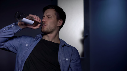 Drunkard father drinking vodka, girl standing by door, psychological trauma