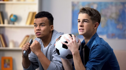 Best multiracial friends unhappy with football game score, favorite team losing