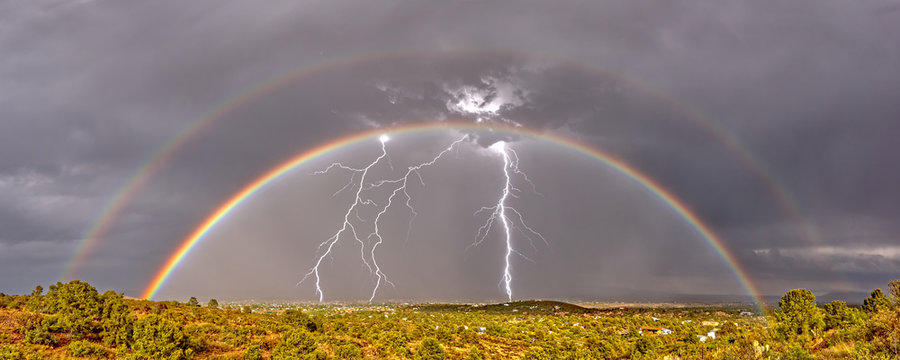 A Double Rainbow, Lightning strikes and a thunderStorm approaching in a rural landscape, Chino Valley, Arizona, USA