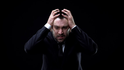 Anxious male employee suffering stress, mental disorder, business failure crisis