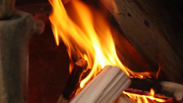 Pan down over wood burning in a chiminea