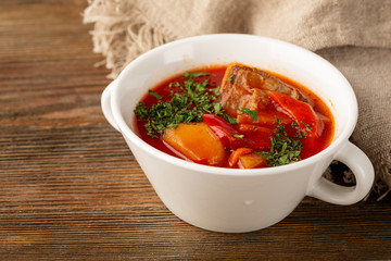 Beetroot rustic soup borsch close-up in white bowl