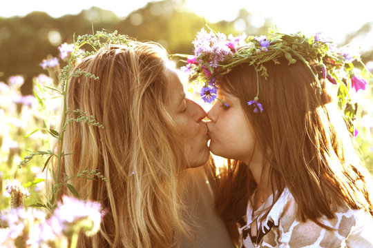 Mother and daughter kissing
