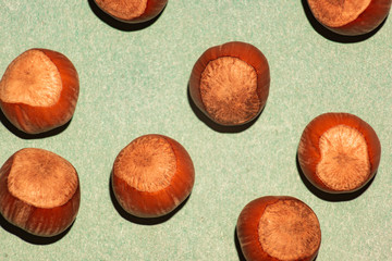Background from hazelnuts on green craft paper from above