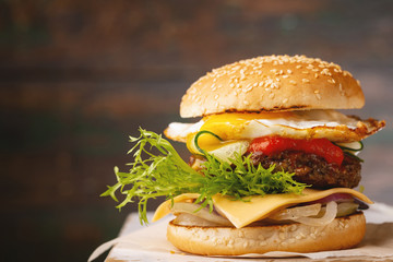 Gourmet burger with beef on wooden background