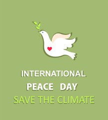 Greeting pastel green card with paper cut out dove with olive branch and International Peace day and save the climate lettering. Flat design