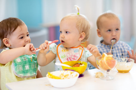 kids children babies eating healthy food in kindergarten or at daycare