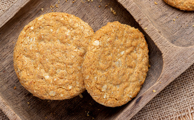 Homemade oat and wholemeal biscuits isolated on brown wooden tray. Its are a nutrient-rich food associated with protein, fiber and no artificial flavoursor or colour added.