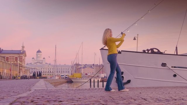 Scandinavian Woman In Helsinki Harbor Taking Photos