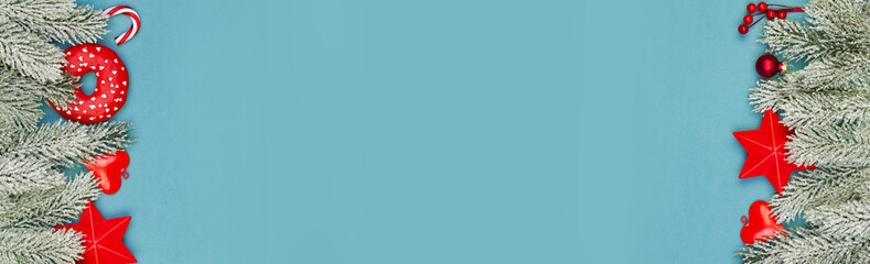 Christmas holidays banner background. Colorful Xmas composition with red holly berries and green fir branch on blue background