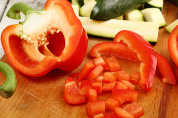 Slices of Red Bell Pepper and Zucchini on wooden board