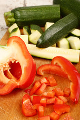 Slices of Red Bell Pepper and Zucchini on wooden board