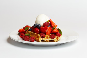Belgian waffle with ice cream and a berries