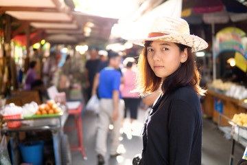 Asian woman wear a cowboy hat in the street market thailand copy space