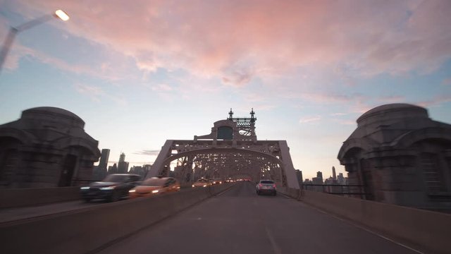 dusk driving onto Queensboro Bridge towards Manhattan