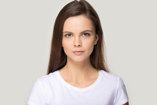 Headshot portrait of millennial young woman isolated in studio