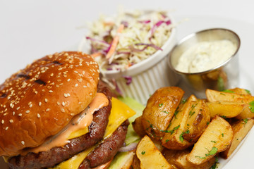 burger with double pork chop and baked potatoes