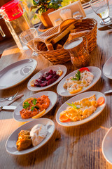 traditional turkish appetizers on table in evening sun light and ayran in a copper glass