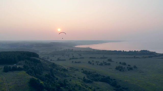 Natural landscape and the paraplane flying over it