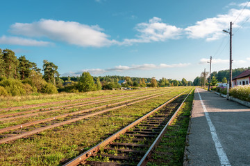 Railroad tracks extending into the distance. Railway station in a small town. Uglich, Russia.