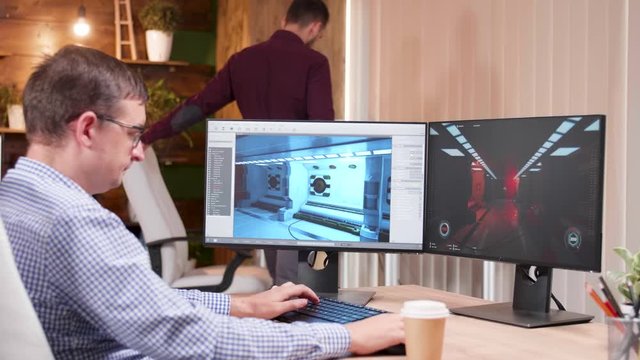 Game designer developing graphics for new game using a modern software.