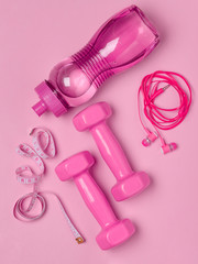 Pink fitness accesories on background