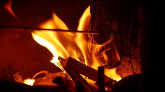 Slow mo Marshmallows being roasted in a wood fire