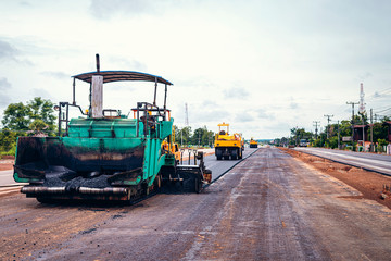 Road works in the city. Working on special equipment cut off the old asphalt on a Sunny summer day