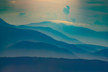 Wooded hills in the haze in the evening