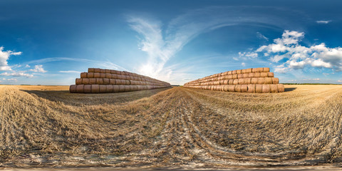 full seamless spherical hdri panorama 360 degrees angle view among harvested field with huge straw...