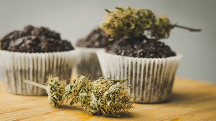 Homemade cakes with cannabis and buds of marijuana. Concept of using marijuana in food industry.