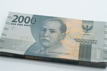 A close up shot of indonesian rupiah banknote of two thousand rupiahs (rp. 2000) denomination with Mohammad Hoesni Thamrin portrait printed on the paper