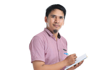 Asian male writing on his diary with pink t-shirt