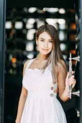 Light portraits of a woman in a restaurant. Beautiful girl blogger in the Park.