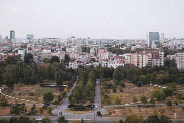 Fototapeta na wymiar Cityscape of old part of Bucharest, with Izvor Park in the foreground, with many worn out buildings, as seen from the Palace of Parliament