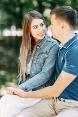 Fototapeta premium Happy people enjoy the good weather. Beautiful couple walking in the Park in the summer.