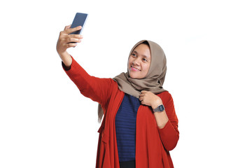 Happy beautiful asian woman smiling wearing hijab doing self phone or selfie