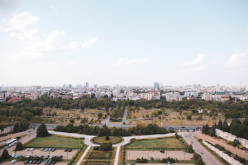 Cityscape of old part of Bucharest, with Izvor Park in the foreground, with many worn out buildings, as seen from the Palace of Parliament