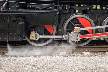 Detailed view of the wheels an driving of an old steam locomotive