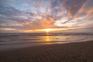 Colored clouds during sunset at the beach