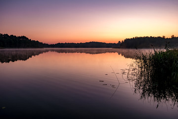 Fototapeta na wymiar panorama on huge lake or river in morning with beautiful awesome pink sunrise