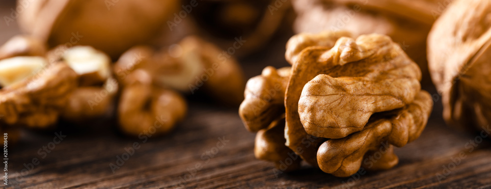 Canvas Prints walnuts. kernels and whole nuts on wooden rustic table closeup, banner