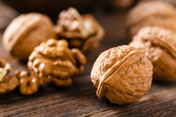 Walnuts. Kernels and whole nuts on wooden rustic table