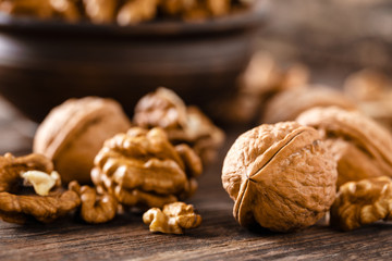 Walnuts. Kernels and whole nuts on wooden rustic table