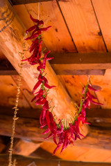 Dry pepper hang under a wooden ceiling