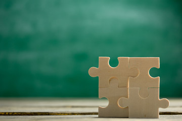 Creative solution for idea - business concept, jigsaw puzzle on the blackboard