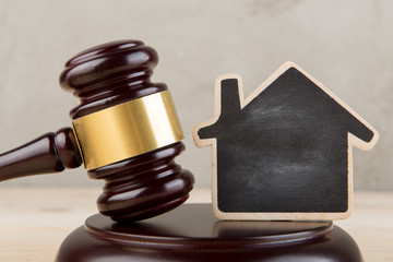 Real estate concept -auction gavel and little house with copy space