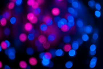 Beautiful blurred bokeh background  with blue and purple and red circles for holiday and Christmas cards