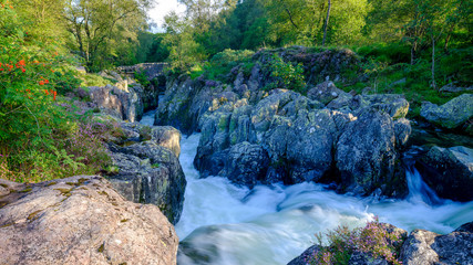 The old packhorse bridge known as Birk's Bridge across the river Duddon near Seathwaite in the Lake District National Park.